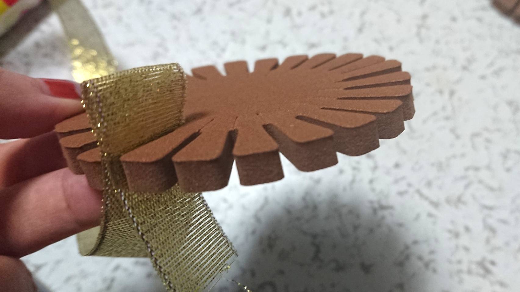  Insert the ribbon into the groove of the Rosette Maker
