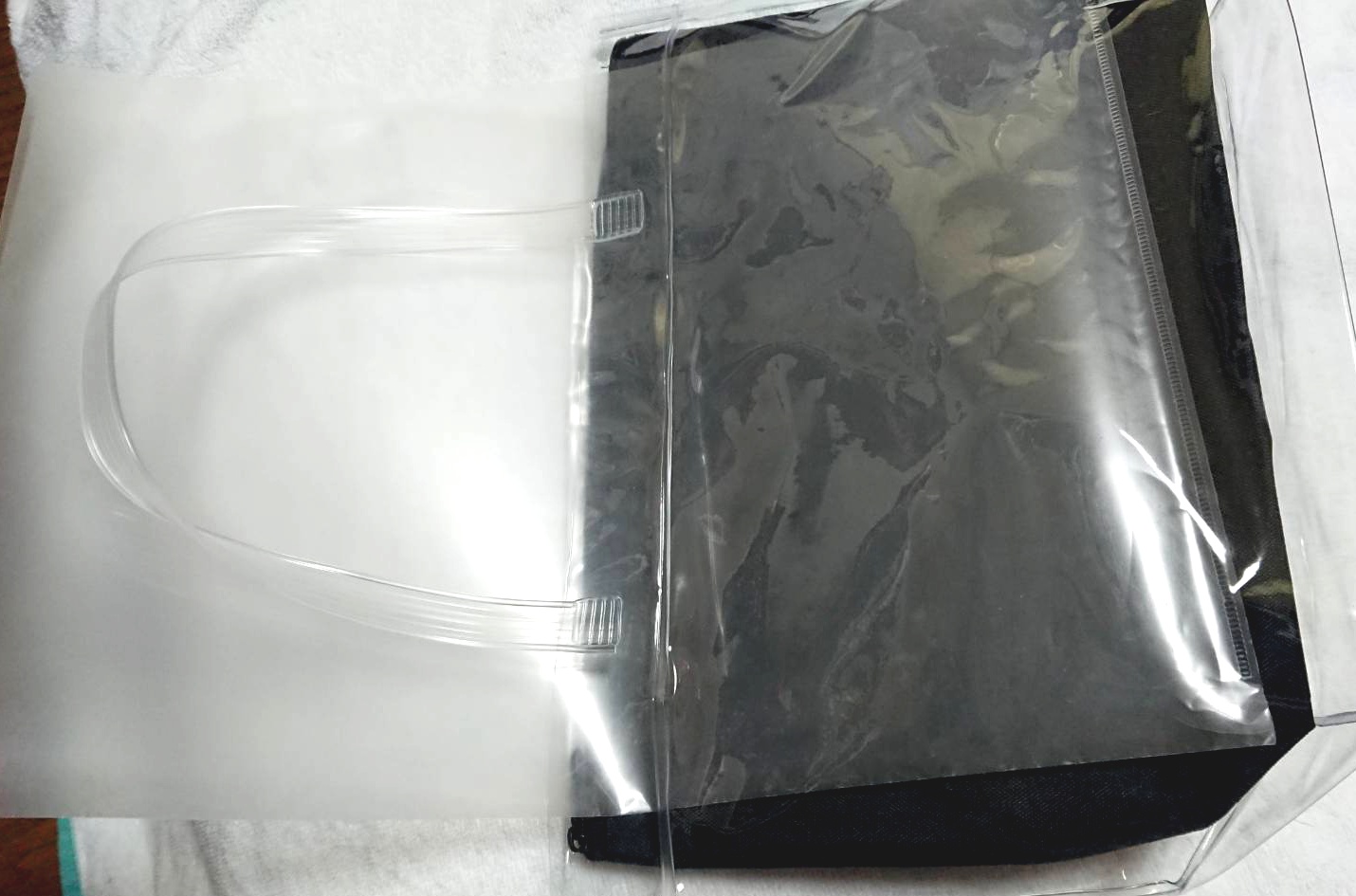 Cut the clear file to the size of the bag
